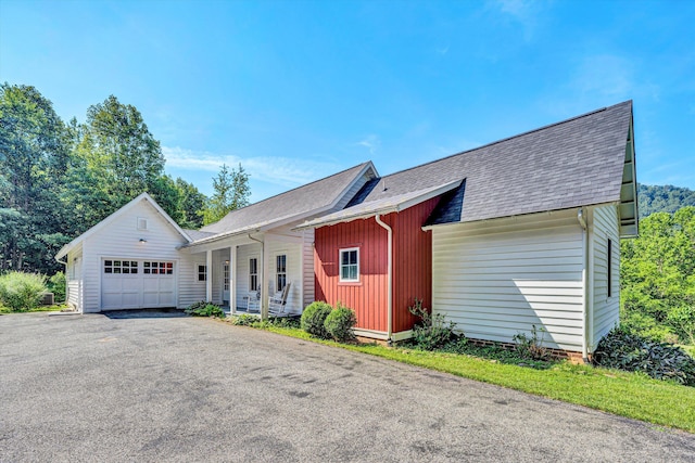 6820 Dawnwood Rd, Roanoke, VA 24018 - view of front facade with a shingled roof, a porch, an attached garage, asphalt driveway, and board and batten siding