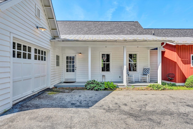 6820 Dawnwood Rd, Roanoke, VA 24018 - doorway to property with covered porch, roof with shingles, an attached garage, and asphalt driveway