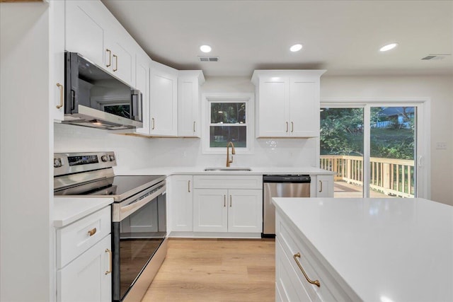 2315 Vale Ave, Roanoke, VA 24012 - kitchen featuring appliances with stainless steel finishes, light wood finished floors, light countertops, white cabinets, and recessed lighting