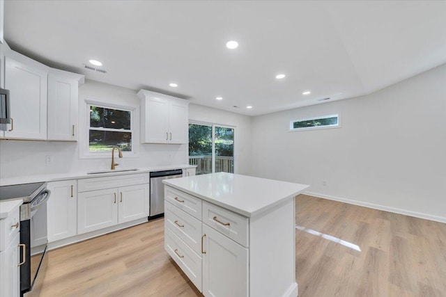 2315 Vale Ave, Roanoke, VA 24012 - kitchen with appliances with stainless steel finishes, light wood finished floors, light countertops, white cabinetry, and recessed lighting