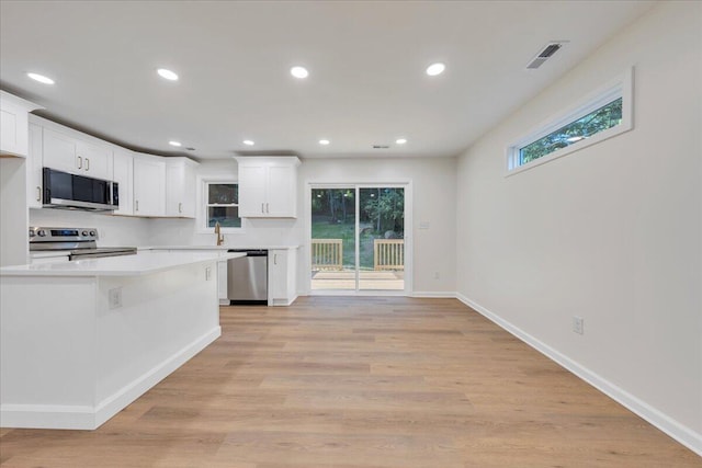 2315 Vale Ave, Roanoke, VA 24012 - kitchen featuring stainless steel appliances, white cabinetry, light countertops, recessed lighting, and light wood finished floors