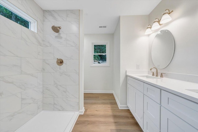 2315 Vale Ave, Roanoke, VA 24012 - full bath with tiled shower, double vanity, and wood finished floors
