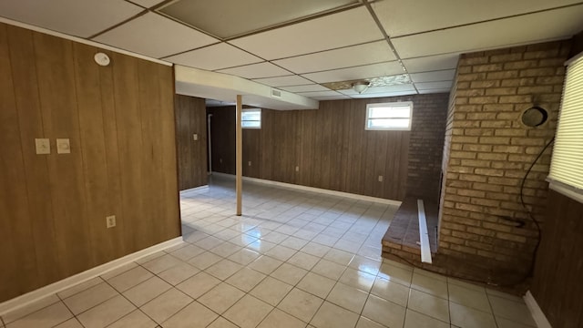 2315 Meadowbrook Rd NW, Roanoke, VA 24017 - basement featuring light tile patterned floors, a paneled ceiling, and wooden walls
