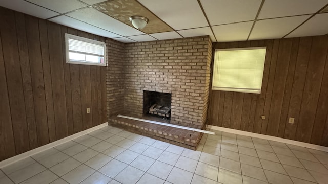 2315 Meadowbrook Rd NW, Roanoke, VA 24017 - below grade area featuring tile patterned floors, a drop ceiling, a brick fireplace, and wood walls