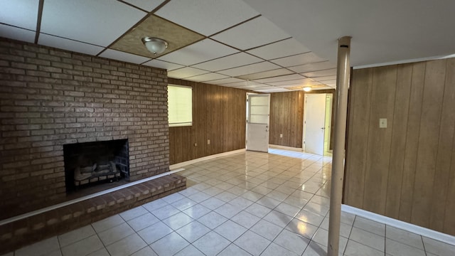 2315 Meadowbrook Rd NW, Roanoke, VA 24017 - unfurnished living room with a brick fireplace, light tile patterned floors, wood walls, and a paneled ceiling
