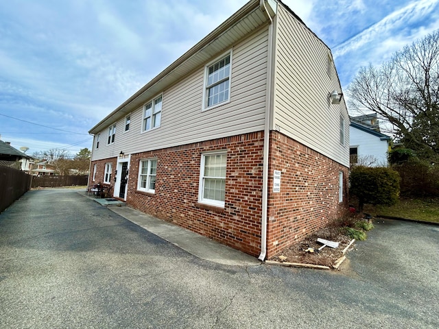 426 Walnut Ave SE, Roanoke, VA 24014 - view of side of home with brick siding, a patio area, and asphalt driveway