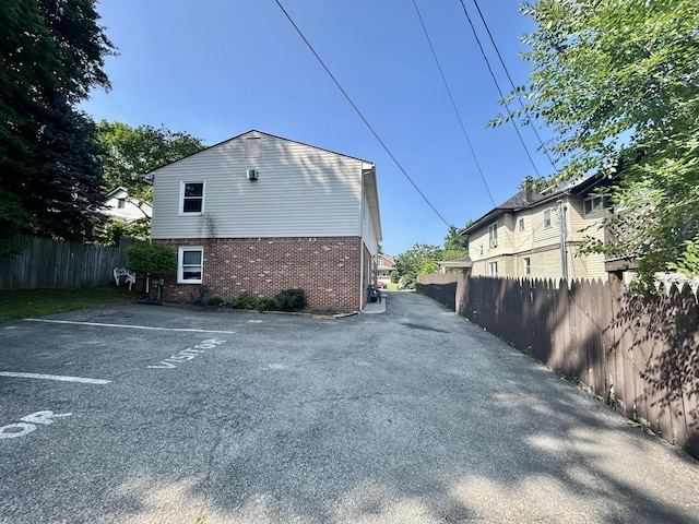 426 Walnut Ave SE, Roanoke, VA 24014 - view of side of home featuring brick siding and uncovered parking