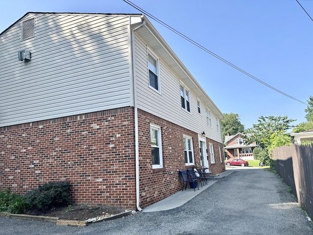 426 Walnut Ave SE, Roanoke, VA 24014 - view of property exterior with brick siding and a patio area