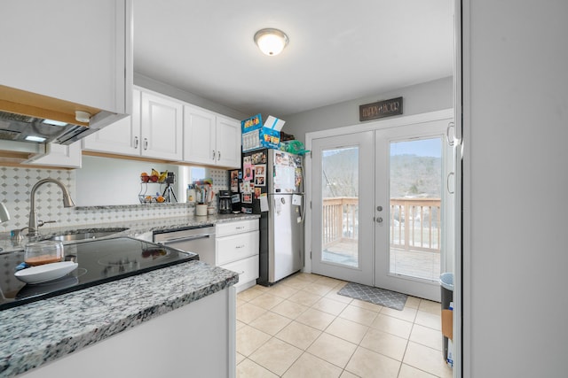 4575 Nelms Ln NE, Roanoke, VA 24019 - kitchen with stainless steel appliances, white cabinetry, french doors, backsplash, and light tile patterned flooring
