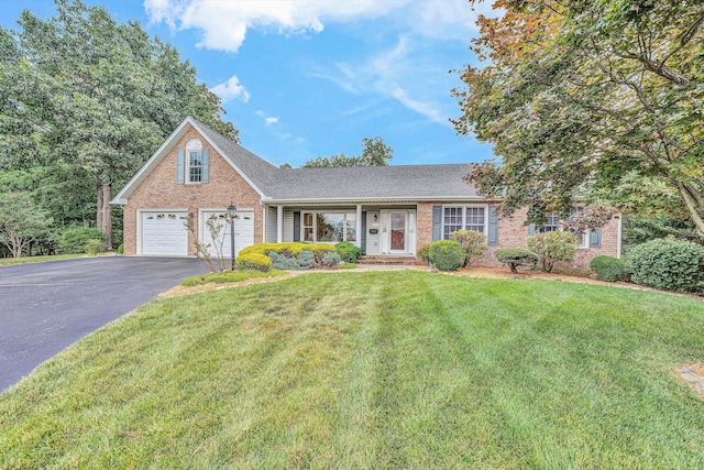 1941 Springmill Rd, Salem, VA 24153 - view of front of property featuring brick siding, asphalt driveway, a front lawn, and a garage
