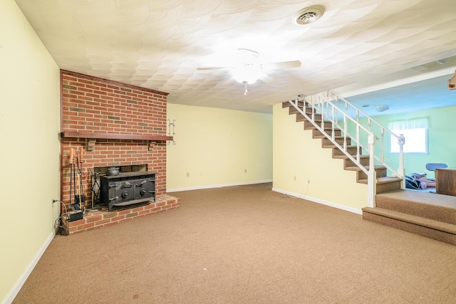 75 Eleanor Ln, Blue Ridge, VA 24064 - unfurnished living room with stairs, carpet, ceiling fan, and a wood stove