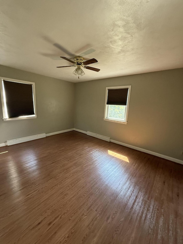 1250 Blacksburg Rd, Fincastle, VA 24090 - unfurnished room with a baseboard heating unit, dark wood finished floors, and a ceiling fan