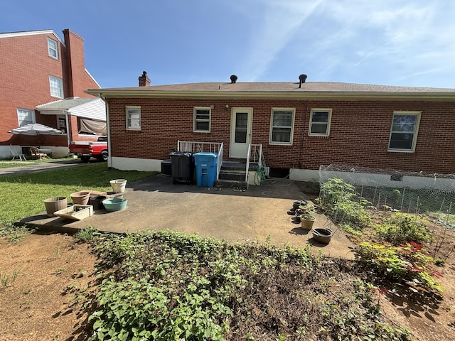 3124 Round Hill Ave NW, Roanoke, VA 24012 - back of property with brick siding, a chimney, and a patio