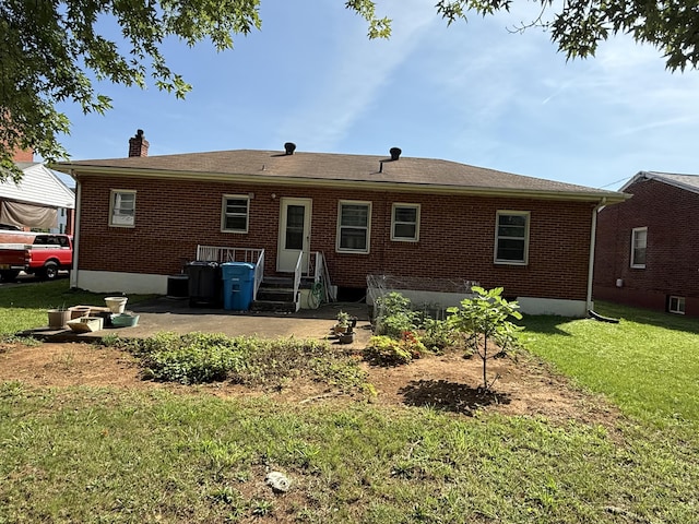 3124 Round Hill Ave NW, Roanoke, VA 24012 - rear view of house with a chimney, brick siding, a yard, and a patio