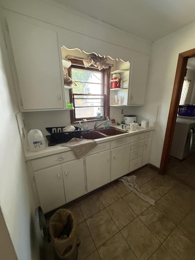 3124 Round Hill Ave NW, Roanoke, VA 24012 - kitchen with washer / dryer, open shelves, white cabinetry, tile patterned floors, and light countertops