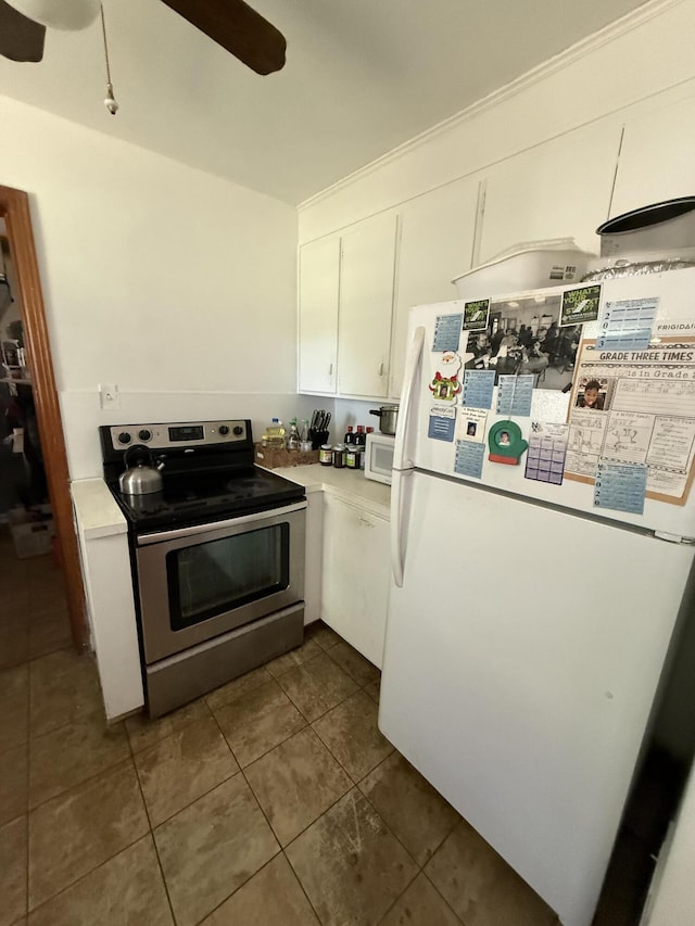 3124 Round Hill Ave NW, Roanoke, VA 24012 - kitchen featuring white appliances, a ceiling fan, white cabinetry, dark tile patterned flooring, and light countertops