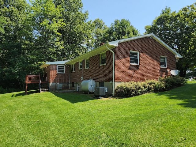82 Twilight Ln, Glade Hill, VA 24092 - rear view of house featuring a lawn, brick siding, a wooden deck, and heating fuel