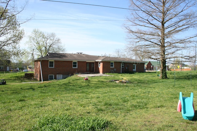 rear view of house featuring a lawn