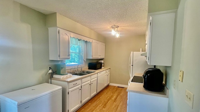 240 N Broadview Ct, Columbia, MO 65201 - kitchen featuring white appliances, white cabinets, light wood-style floors, light countertops, and a textured ceiling
