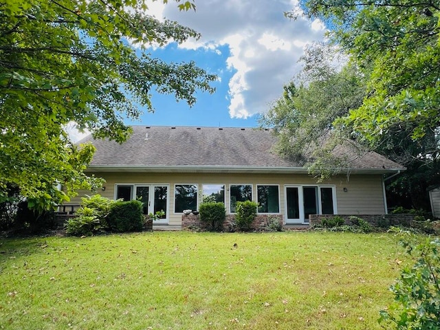 rear view of property with a yard