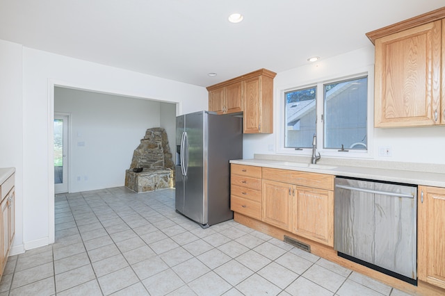 kitchen featuring light tile patterned floors, stainless steel appliances, and sink