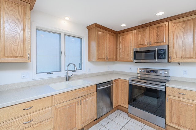 kitchen featuring appliances with stainless steel finishes, light tile patterned floors, and sink