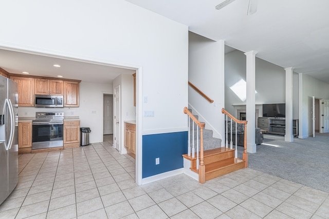 kitchen with stainless steel appliances and light colored carpet