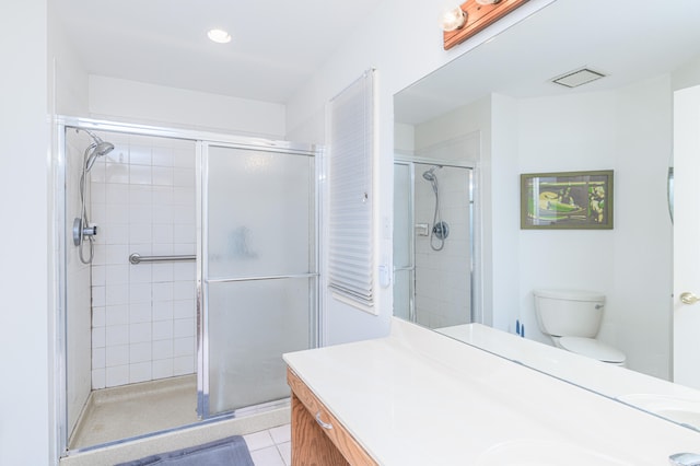 bathroom featuring vanity, toilet, tile patterned floors, and a shower with door