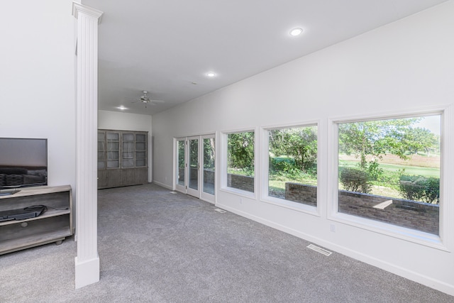 carpeted living room featuring ceiling fan and vaulted ceiling