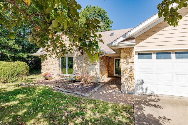 view of front of home with a garage and a front lawn