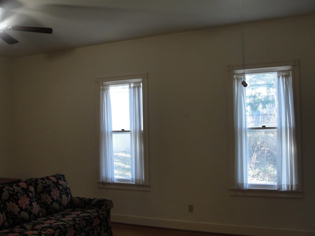 sitting room featuring a healthy amount of sunlight and ceiling fan