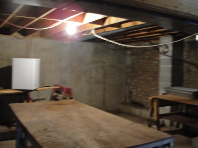 basement featuring brick wall