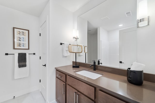 bathroom with tile flooring and vanity