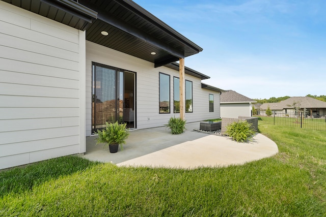 back of house featuring a patio and a yard