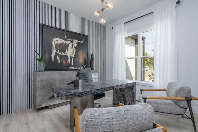 home office with a chandelier and light wood-type flooring