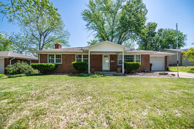ranch-style house featuring an attached garage, brick siding, a front lawn, and a chimney