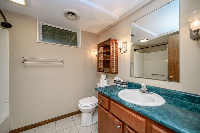 bathroom with a shower, tile patterned floors, toilet, baseboards, and vanity