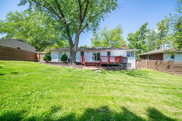 back of house with a deck and a chimney