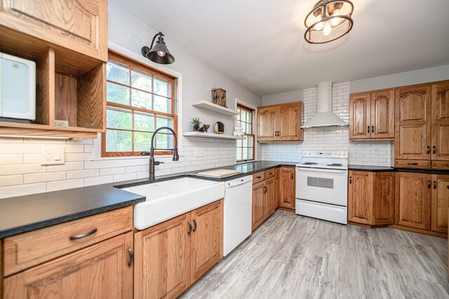 kitchen featuring wall chimney exhaust hood, white appliances, a sink, open shelves, and backsplash