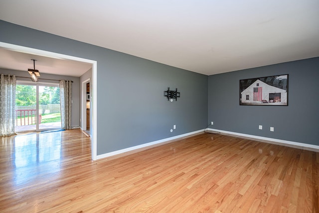 unfurnished room featuring light wood-type flooring and baseboards