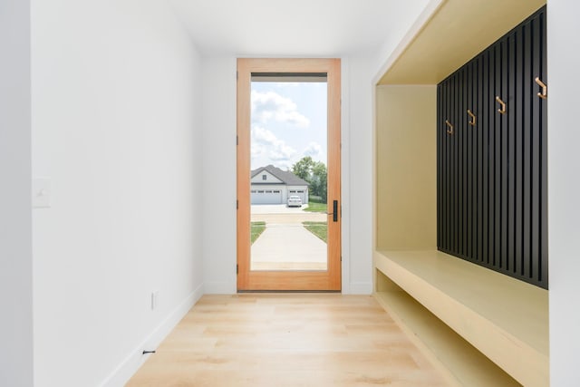 mudroom with baseboards and wood finished floors