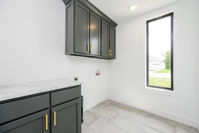 washroom with recessed lighting, washer hookup, baseboards, cabinet space, and electric dryer hookup