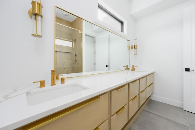 full bath featuring a sink, a shower stall, baseboards, and double vanity