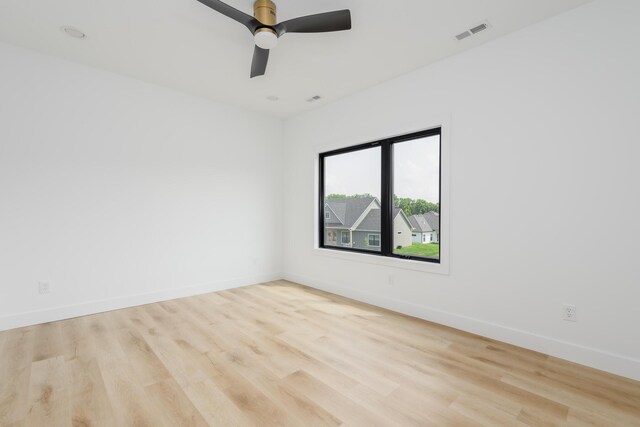 spare room with light wood-type flooring and ceiling fan