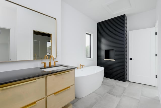 full bath featuring a soaking tub and vanity