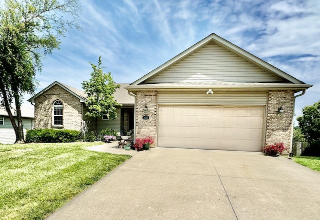 view of front of property with a garage and a front yard