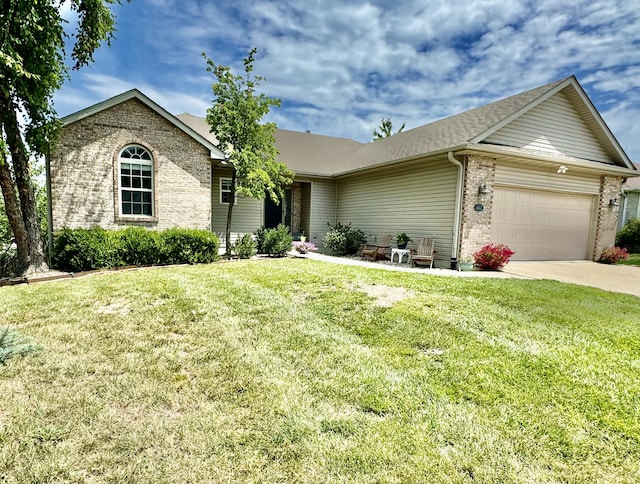 ranch-style house featuring a garage and a front lawn