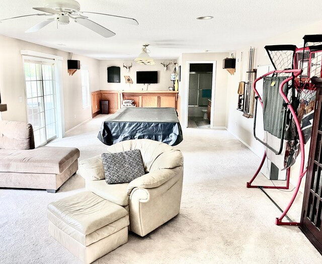 carpeted living room featuring ceiling fan