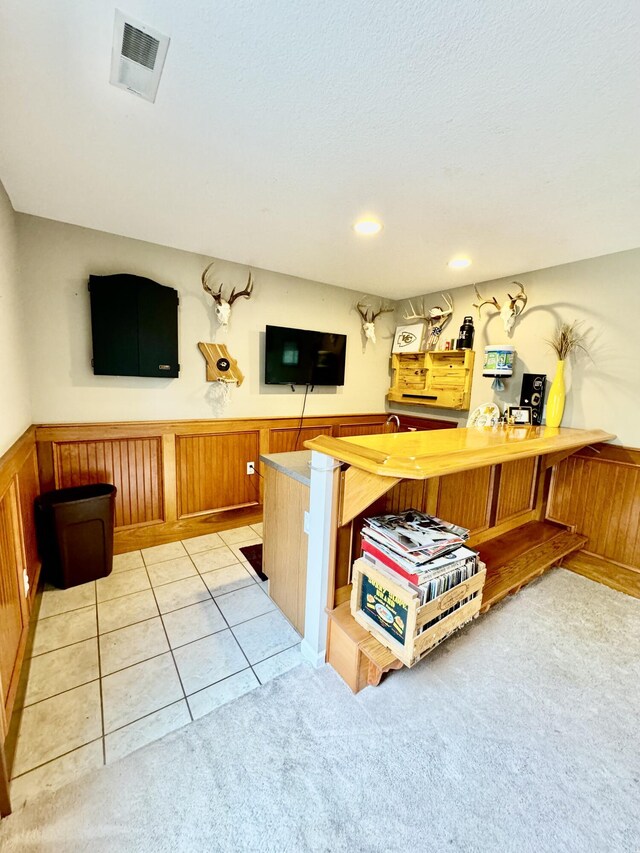 bar featuring light tile patterned flooring