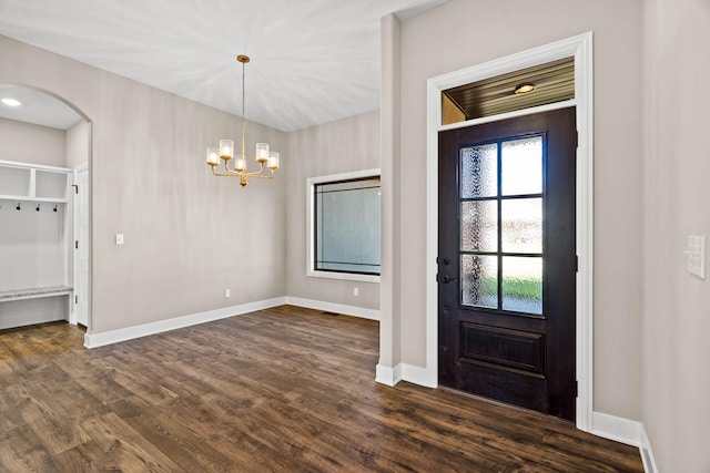 foyer with a notable chandelier and dark hardwood / wood-style floors